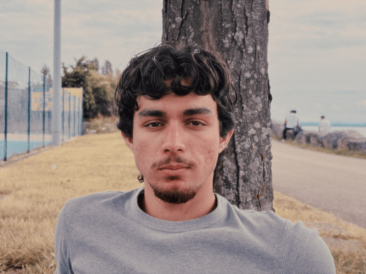 Bedir Ekim beside a tree.